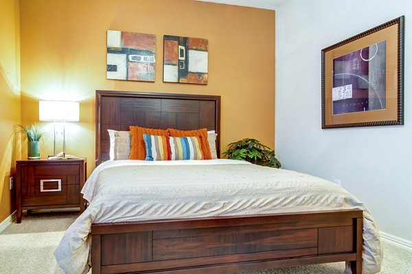 Cozy bedroom with modern decor in Estates at Memorial Heights Apartments, featuring ample natural light and stylish furnishings