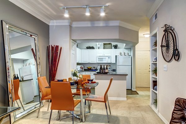 Modern kitchen with stainless steel appliances and granite countertops in Estates at Memorial Heights Apartments
