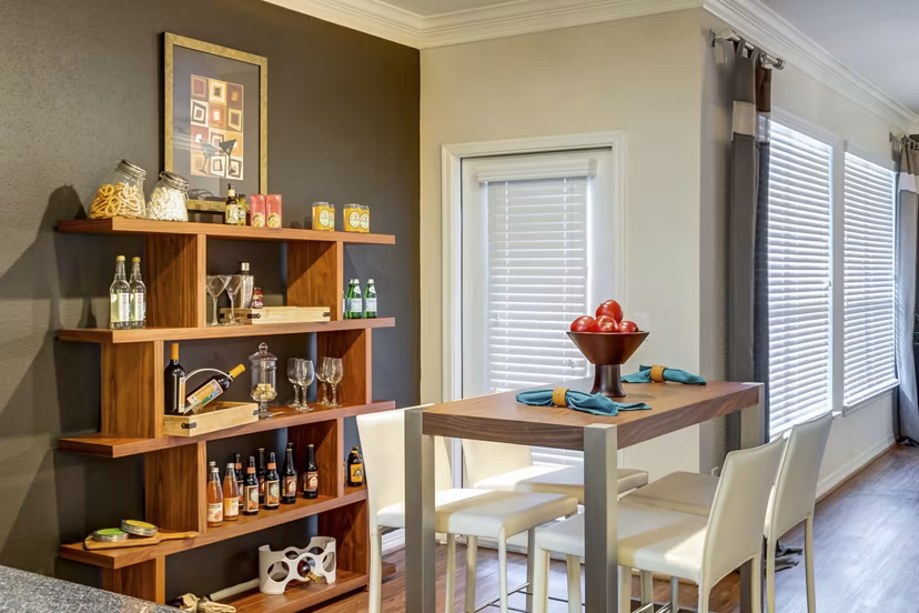 Dining room with elegant lighting and hardwood floors in Estates at Memorial Heights Apartments, luxury living near downtown Houston