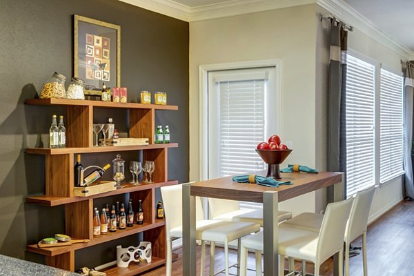 Dining room with elegant lighting and hardwood floors in Estates at Memorial Heights Apartments, luxury living near downtown Houston