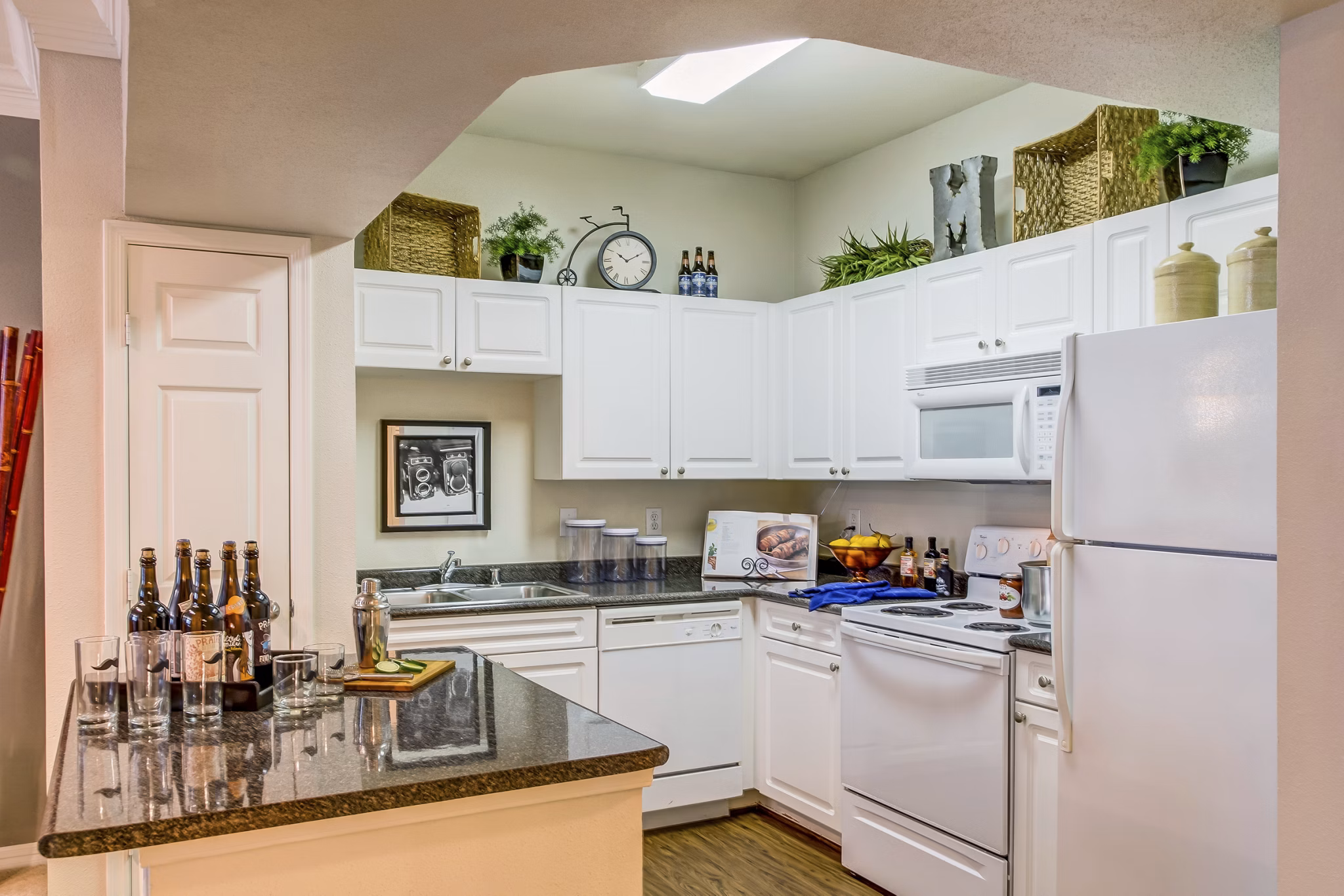 Modern kitchen with stainless steel appliances and quartz countertops at Estates at Memorial Heights Apartments, ideal for luxury living