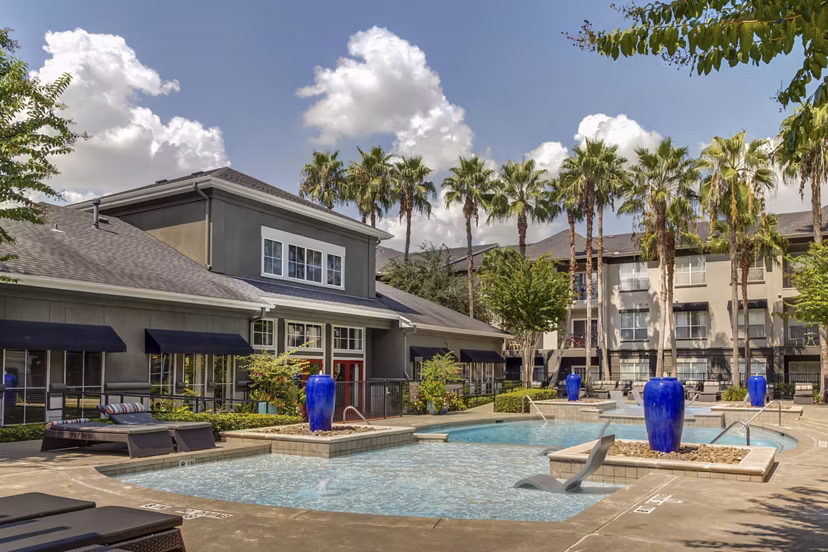 Luxurious pool with lounge chairs at Estates at Memorial Heights Apartments, ideal for relaxation and enjoyment