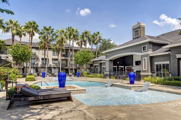 Pool with lush landscaping at Estates at Memorial Heights Apartments
