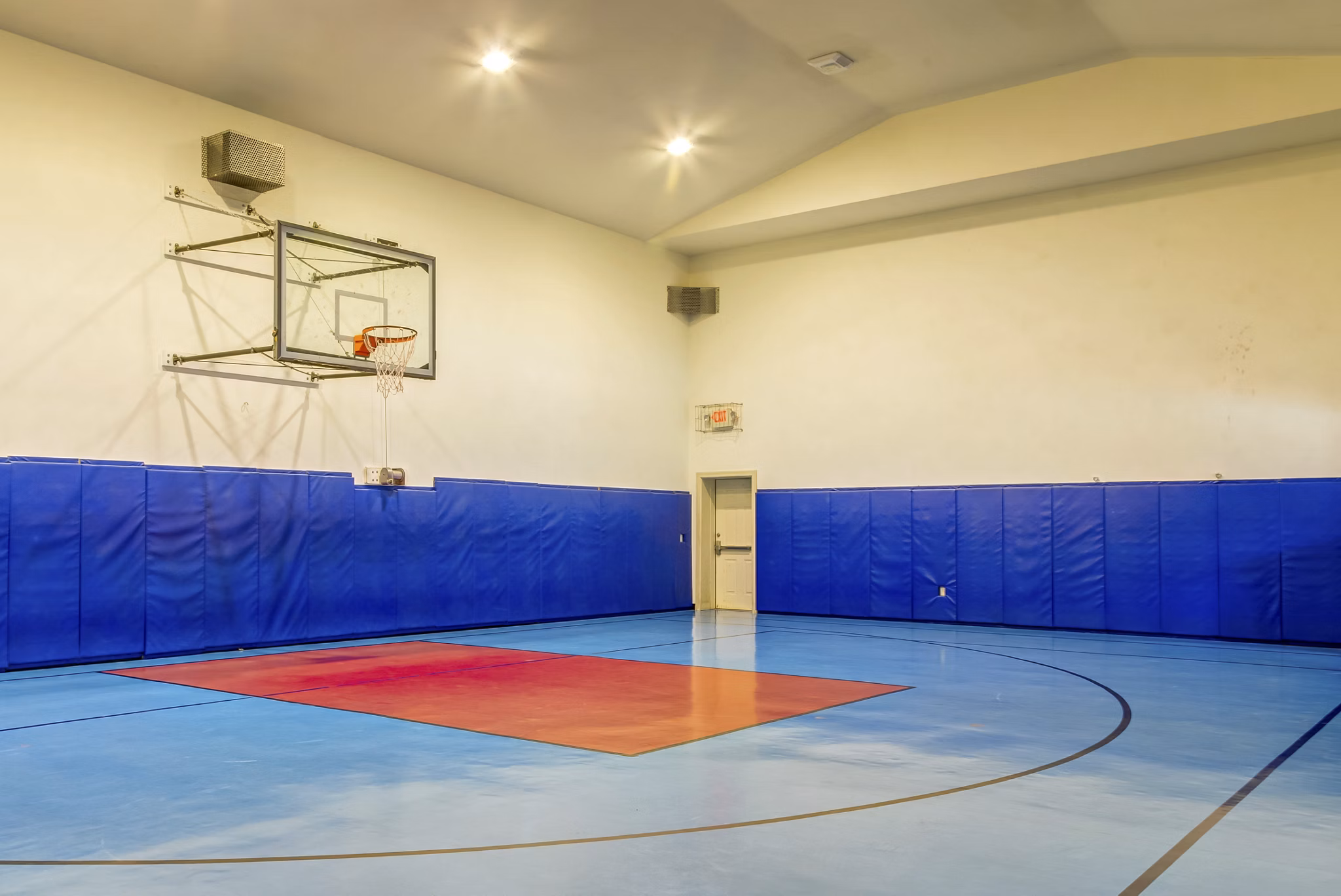 Basketball court at Estates at Memorial Heights featuring modern flooring and hoops