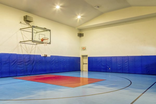 Basketball court at Estates at Memorial Heights featuring modern flooring and hoops