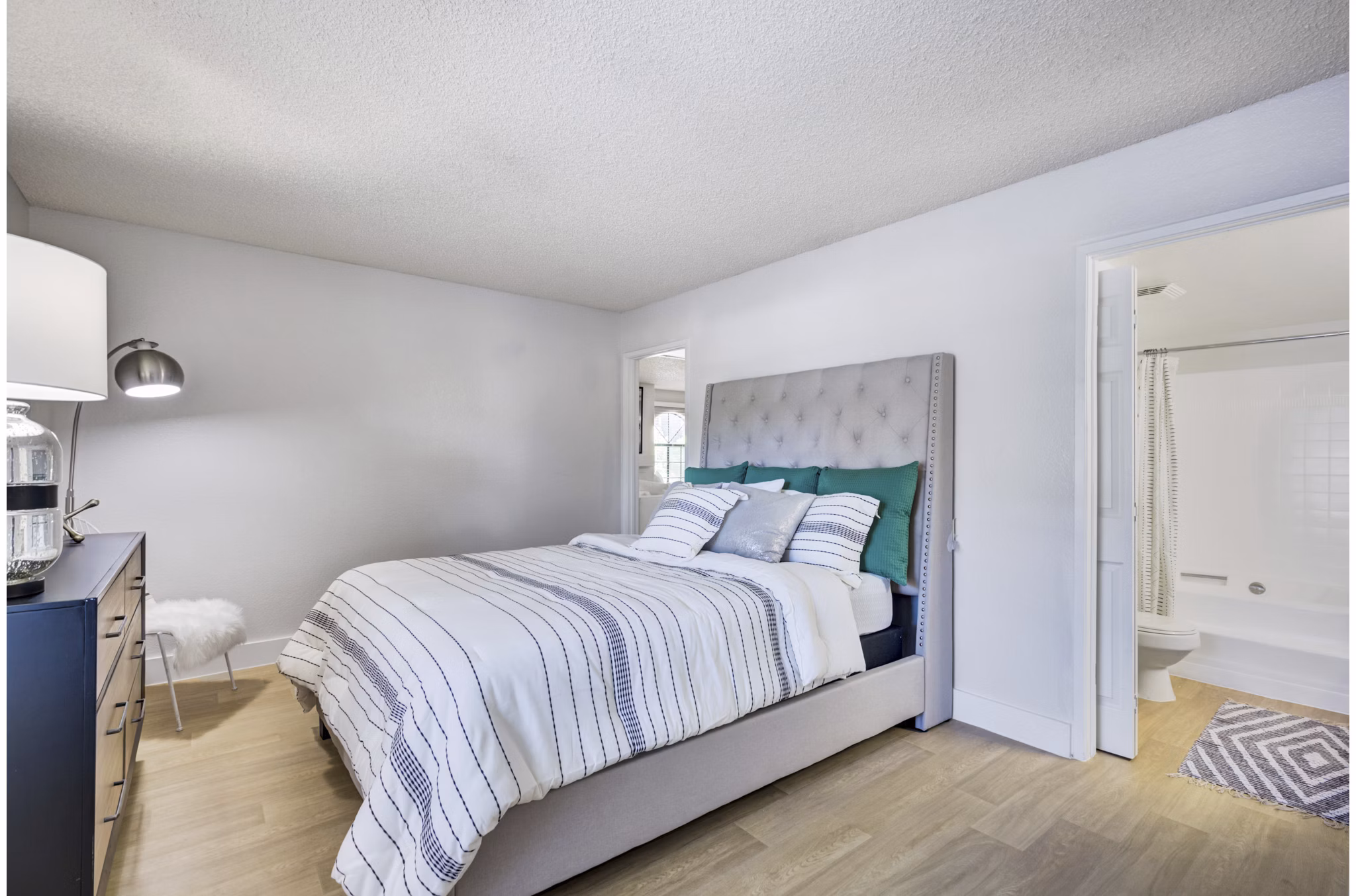 Spacious bedroom with modern furnishings at Montego Bay Apartments