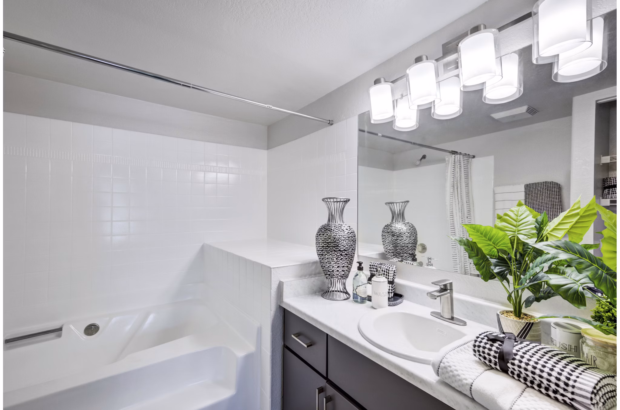 Luxurious bathroom with modern fixtures and elegant tile design at Montego Bay Apartments