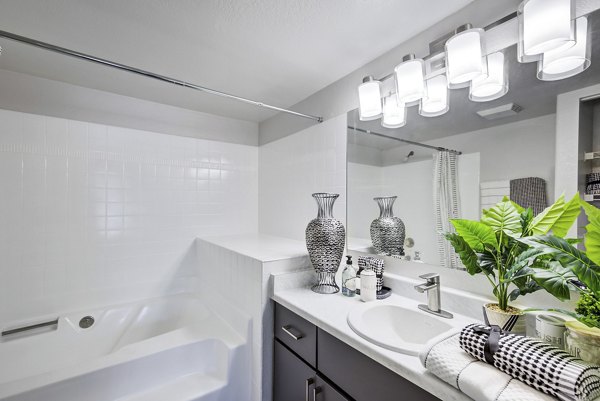 Luxurious bathroom with modern fixtures and elegant tile design at Montego Bay Apartments