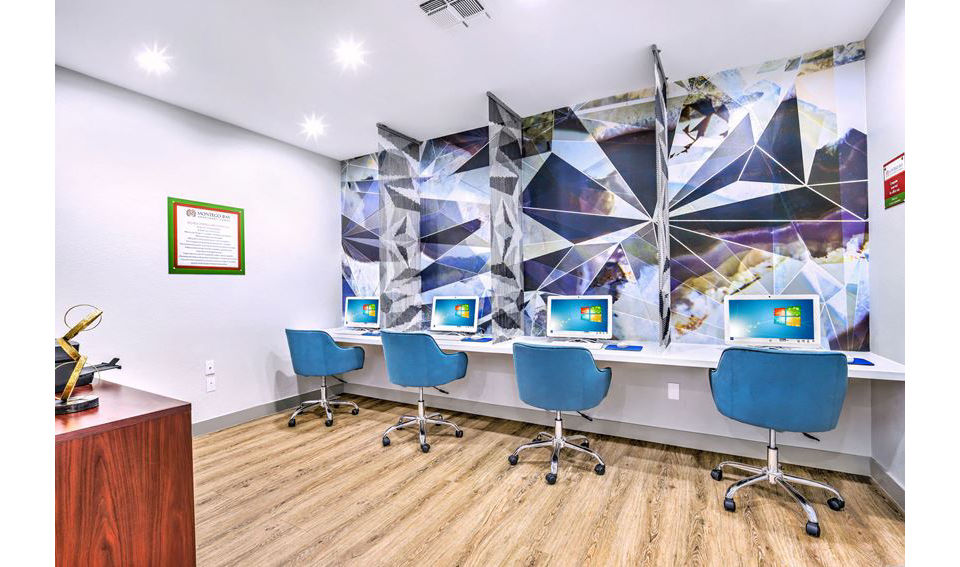 Modern business center with computer stations at Montego Bay Apartments