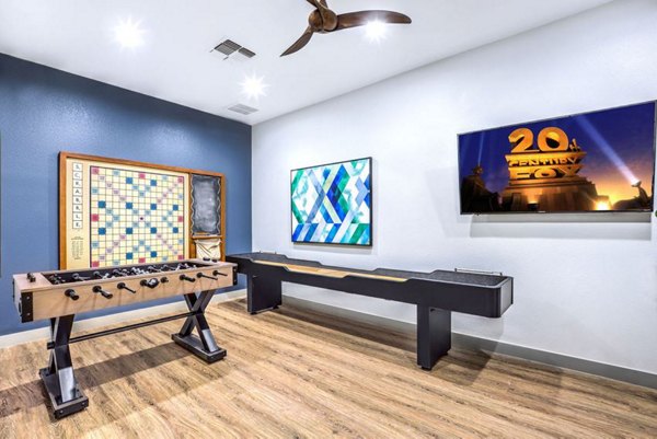 Vibrant game room with billiards and arcade games at Montego Bay Apartments