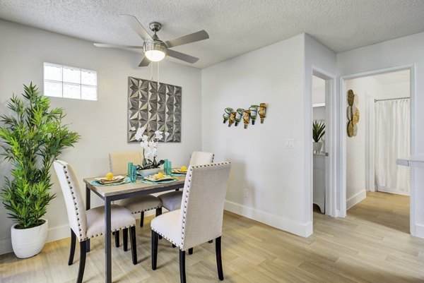 Dining area with modern furnishings at Montego Bay Apartments, featuring elegant decor and open layout