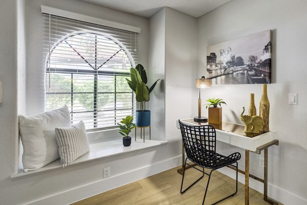 Home office featuring modern desk and natural light at Montego Bay Apartments, luxury space for productivity and comfort