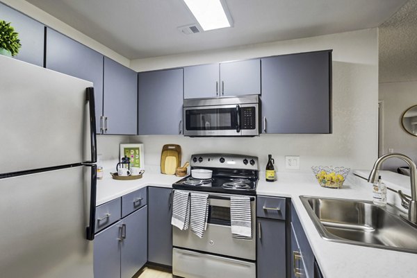 Kitchen with modern appliances and granite countertops in Montego Bay Apartments