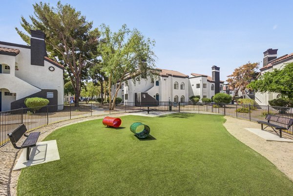 Spacious dog park at Montego Bay Apartments featuring agility course and seating areas for residents