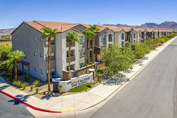 Colton Apartments: Stylish luxury apartment complex with palm trees and multiple buildings in a scenic setting
