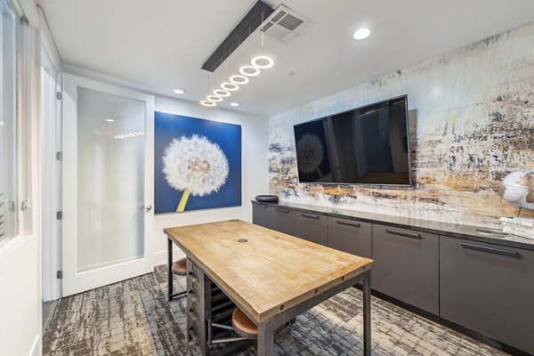 Elegant clubhouse meeting facility at Colton Apartments features modern seating and state-of-the-art technology for productive gatherings