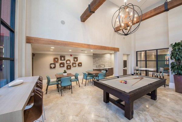 Game room with pool table and seating at Alanza Place Apartments