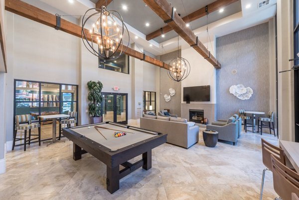 Game room featuring billiards and lounge seating at Alanza Place Apartments