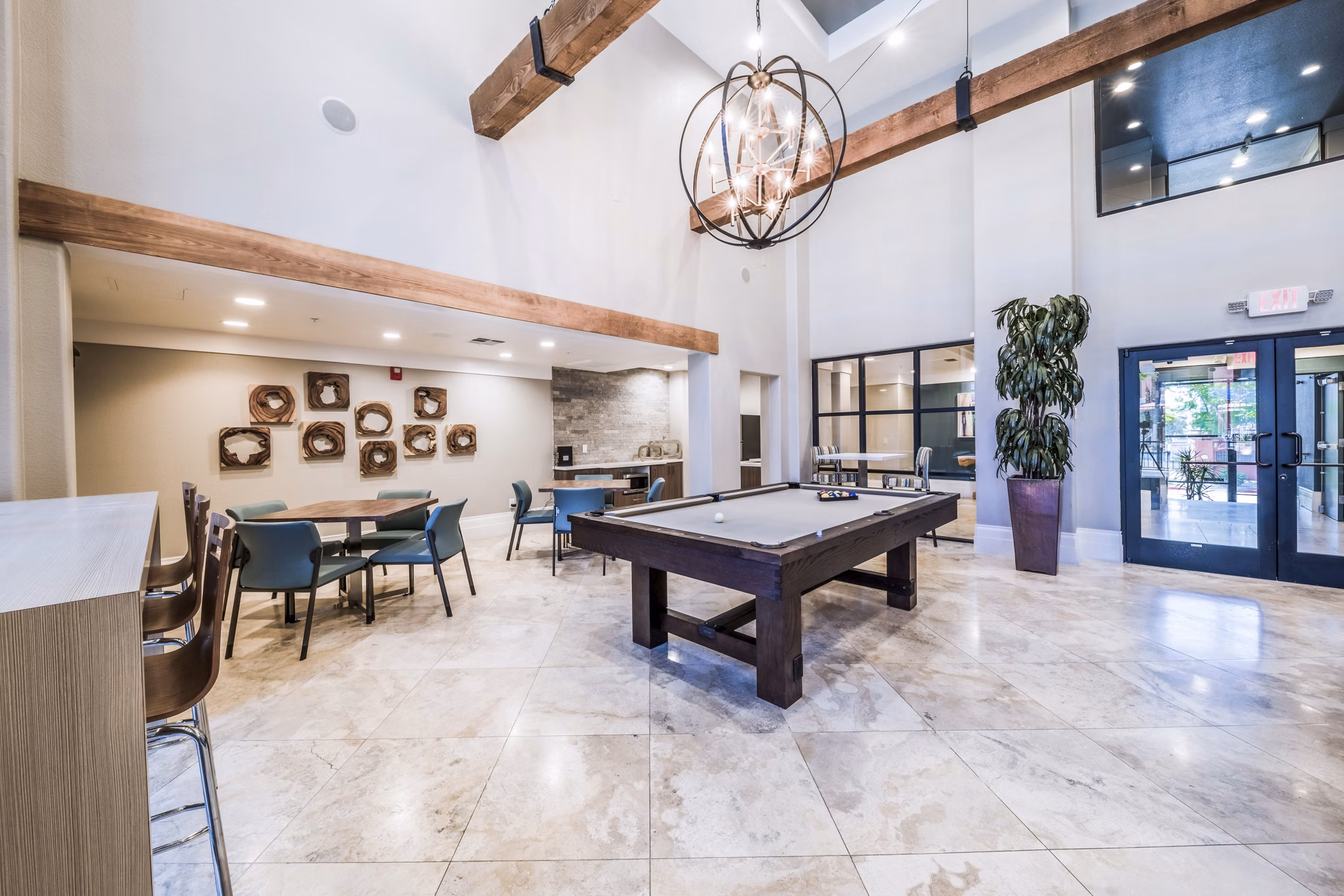 Game room with billiards and seating at Alanza Place Apartments, providing luxury entertainment options for residents