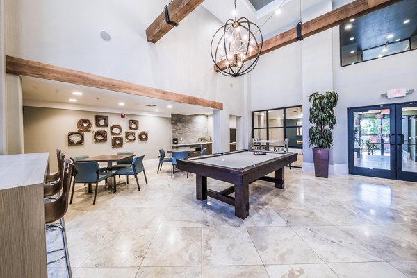 Game room with billiards and seating at Alanza Place Apartments, providing luxury entertainment options for residents