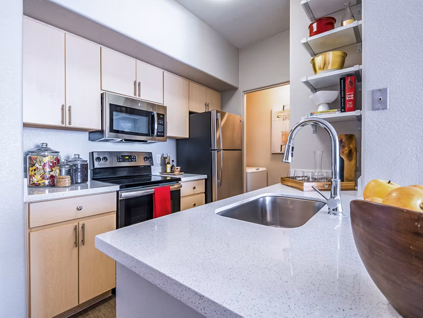 Modern kitchen with stainless steel appliances at Alanza Place Apartments