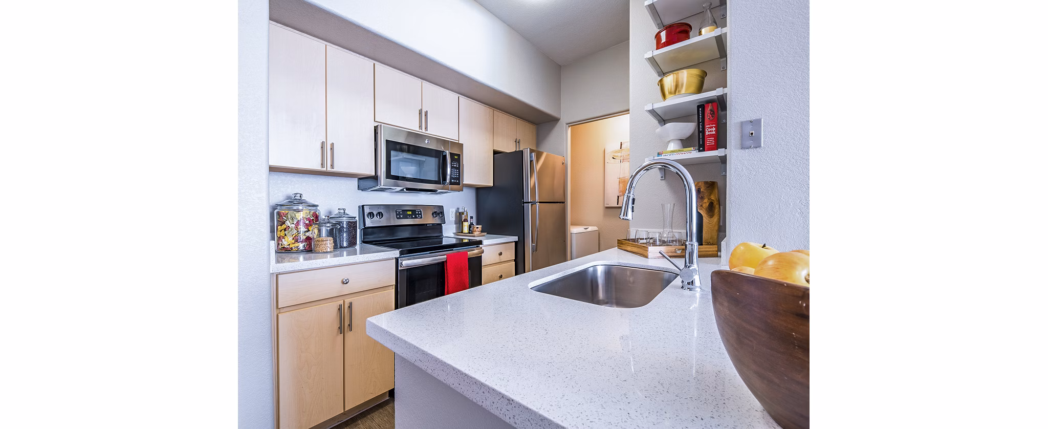 Modern kitchen with stainless steel appliances at Alanza Place Apartments