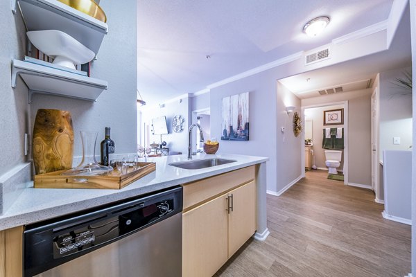 Modern kitchen with stainless steel appliances at Alanza Place Apartments