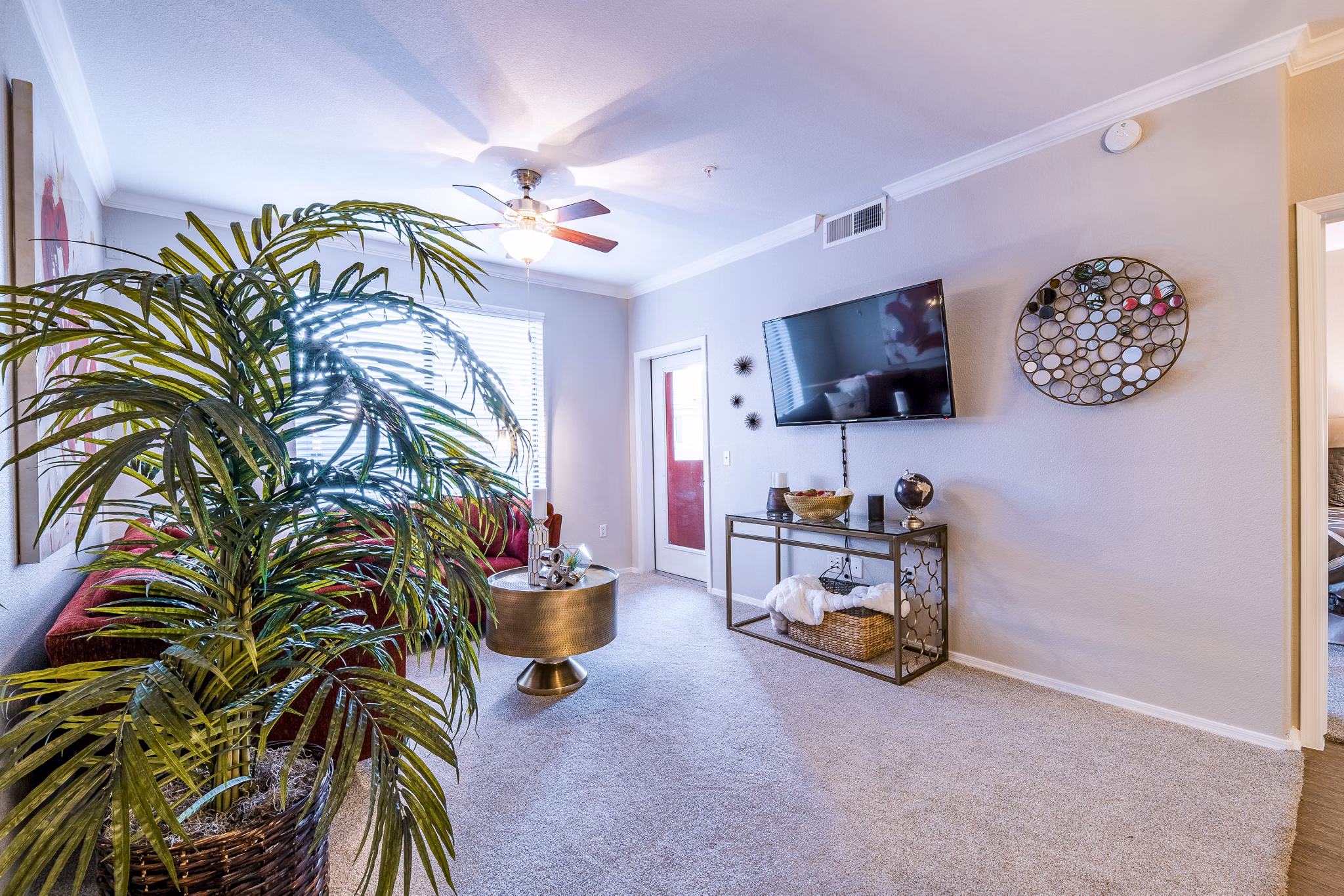 Modern living room with elegant furnishings and large windows at Alanza Place Apartments