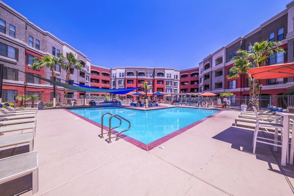 Resort-style pool area with loungers at Alanza Place Apartments, a Greystar luxury community