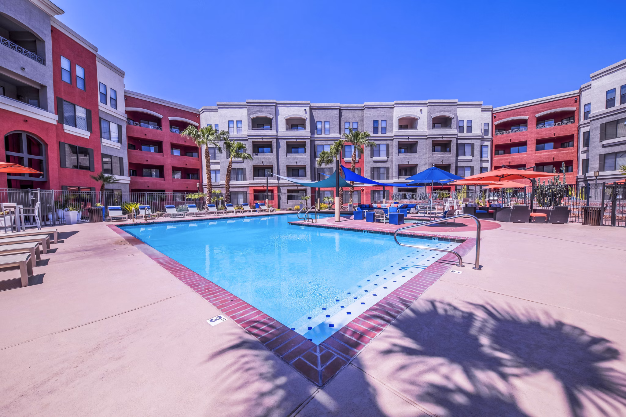 Luxurious pool with lounge chairs at Alanza Place Apartments, perfect for relaxation and social gatherings