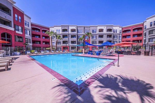 Luxurious pool with lounge chairs at Alanza Place Apartments, perfect for relaxation and social gatherings