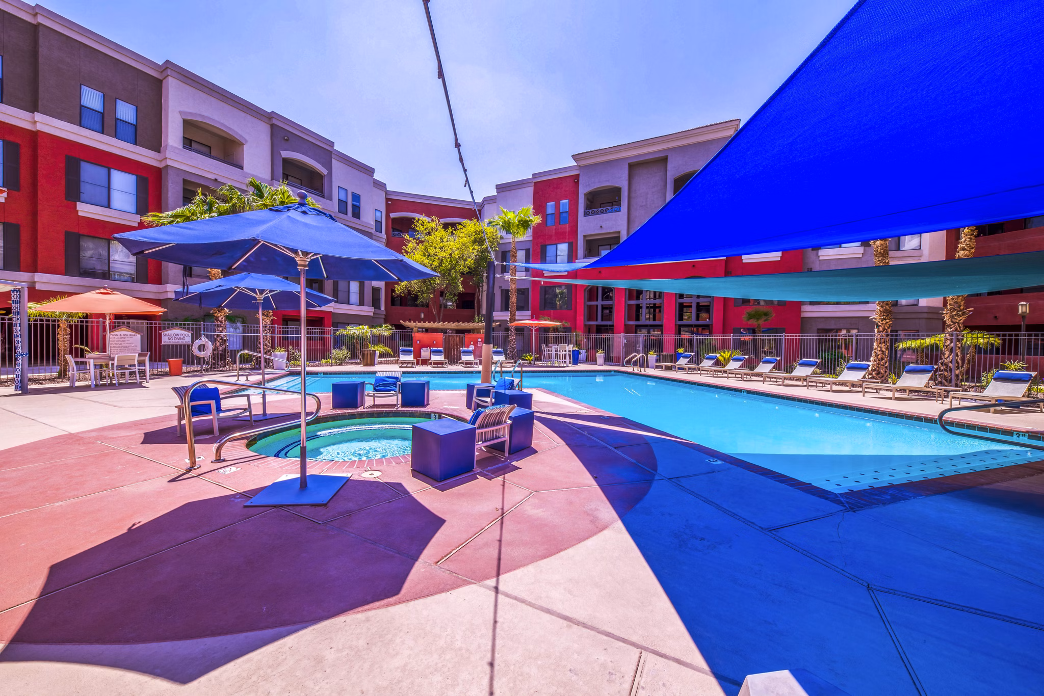 Resort-style pool with lounging areas at Alanza Place Apartments