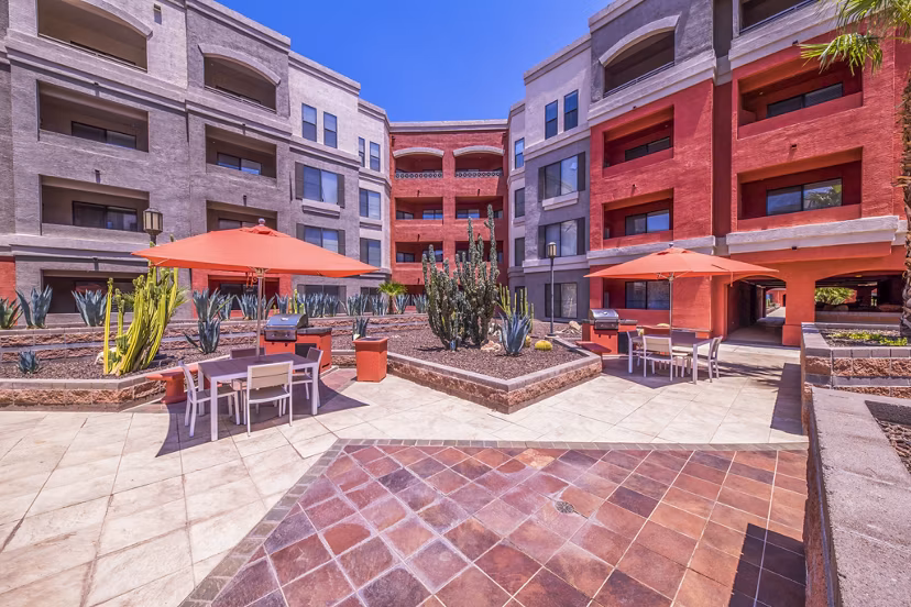 Outdoor grill area at Alanza Place Apartments with modern seating for luxury outdoor dining experiences
