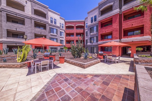 Outdoor grill area at Alanza Place Apartments with modern seating for luxury outdoor dining experiences