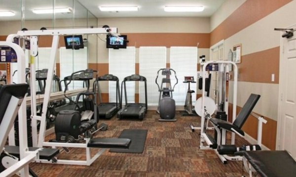 State-of-the-art fitness center at Sendera at Greenway Apartments featuring modern equipment and spacious workout area