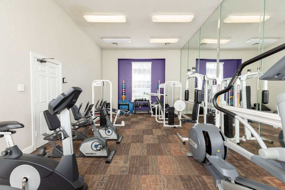 State-of-the-art fitness center at Sendera at Greenway Apartments featuring modern equipment and spacious workout area