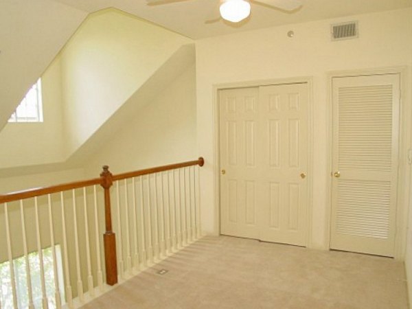 Elegant bedroom with modern decor and large windows at Plaza at River Oaks Apartments