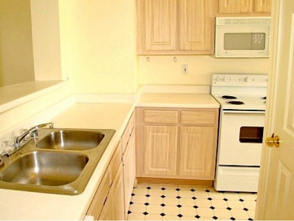 Modern kitchen with granite countertops and stainless-steel appliances in Plaza at River Oaks Apartments