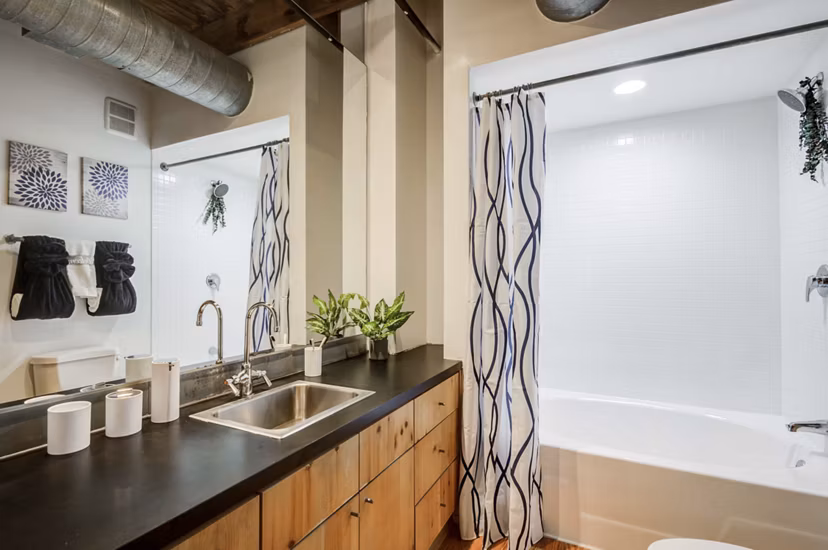 Bathroom featuring sleek fixtures and marble countertops in Mitchell Lofts