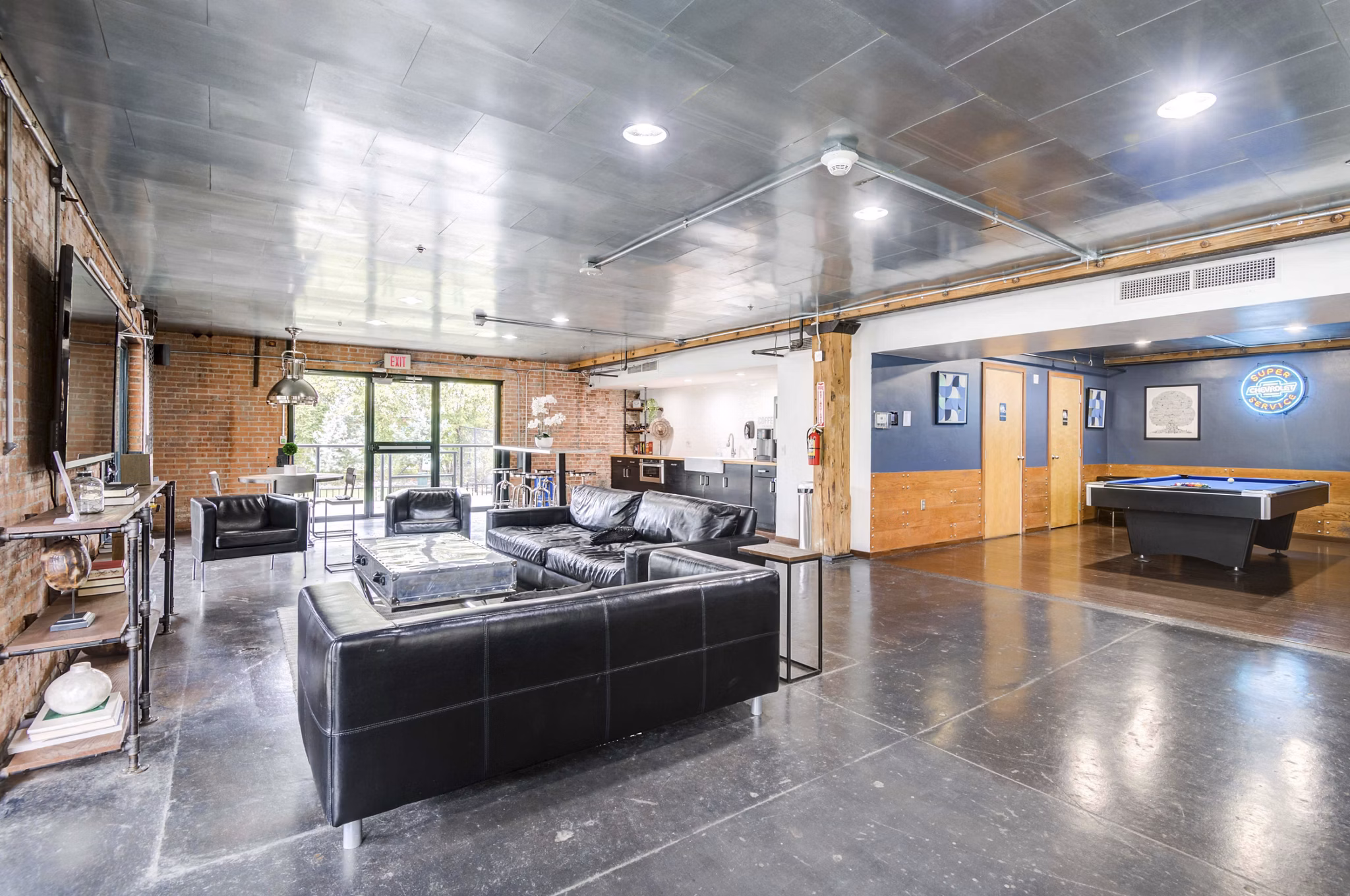 Modern clubhouse with billiards and lounge at Mitchell Lofts, luxury apartments by Greystar