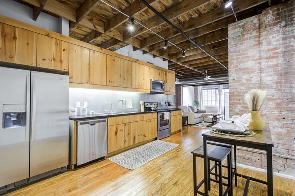 Elegant kitchen with modern appliances at Mitchell Lofts luxury apartments in urban setting