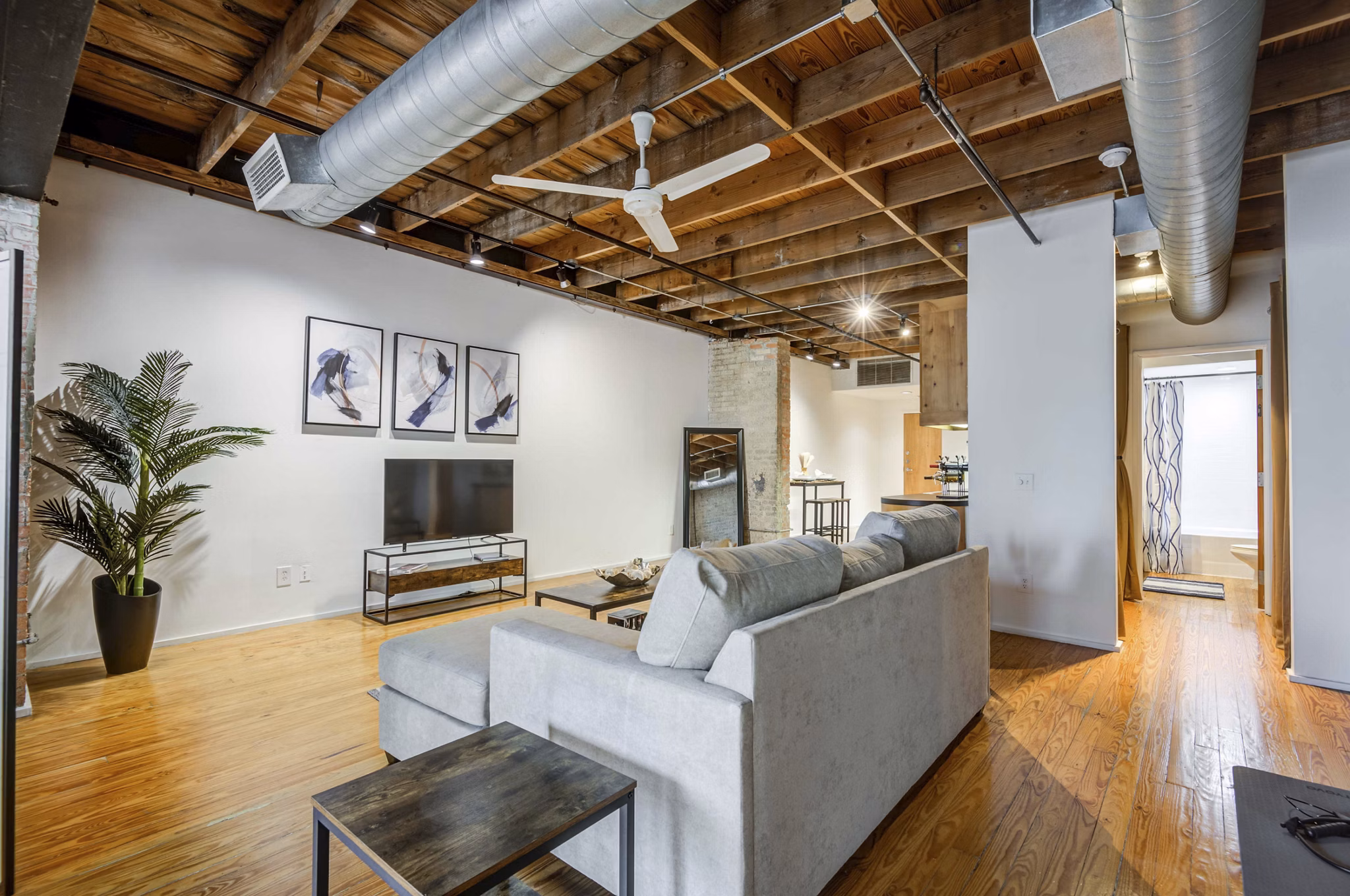Spacious living room with industrial design features in Mitchell Lofts, luxury apartments by Greystar