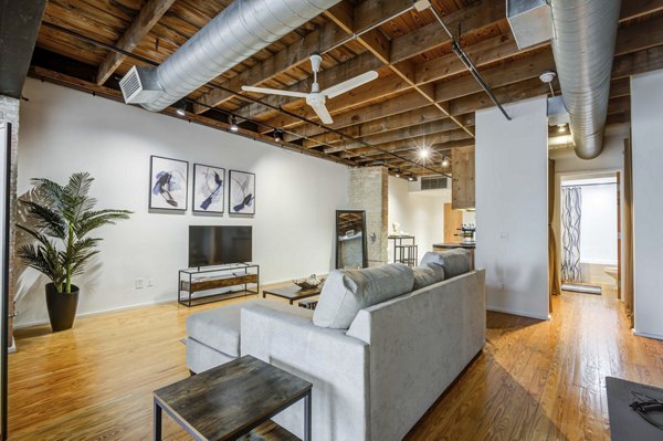 Spacious living room with industrial design features in Mitchell Lofts, luxury apartments by Greystar