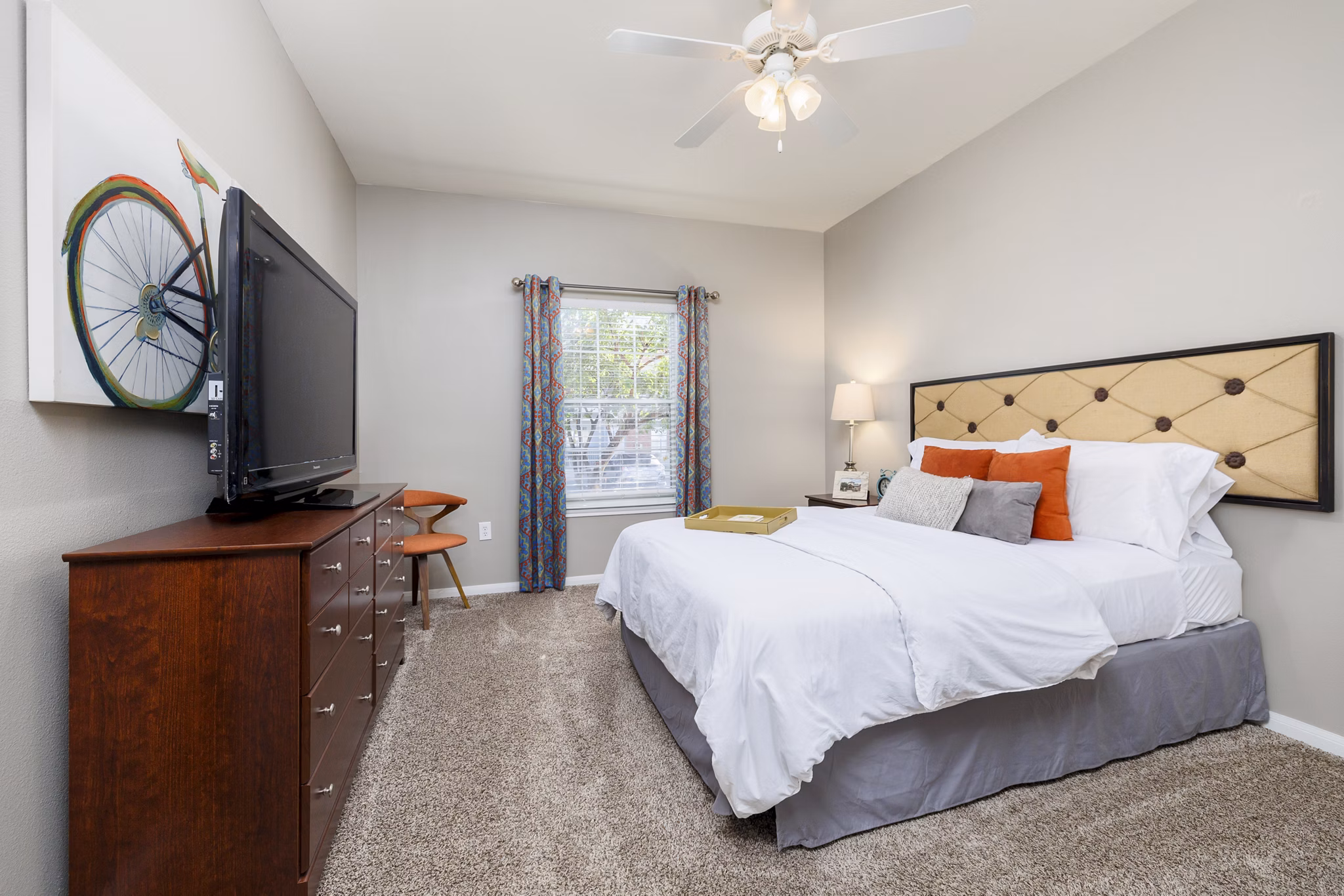 Contemporary bedroom featuring a plush bed and modern decor at Clear Creek Meadows Apartments