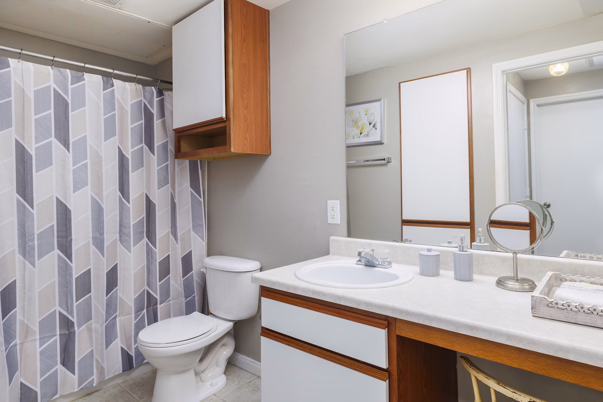 Modern bathroom with sleek fixtures and granite countertops at Clear Creek Meadows Apartments