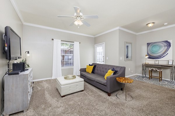 Warm-toned living room with modern furniture in Clear Creek Meadows Apartments, perfect for relaxation and entertainment