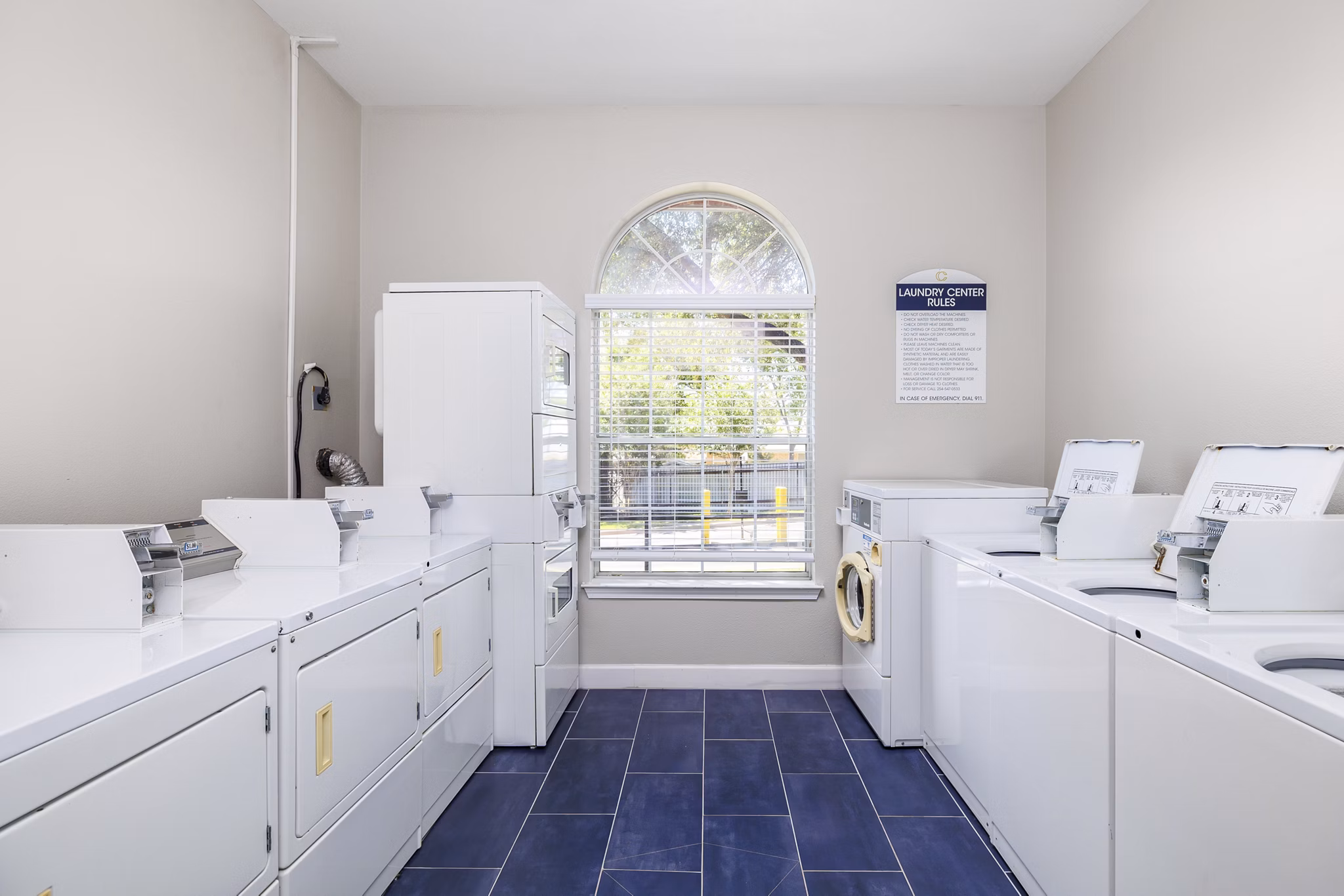 Modern laundry facility with efficient machines at Clear Creek Meadows Apartments