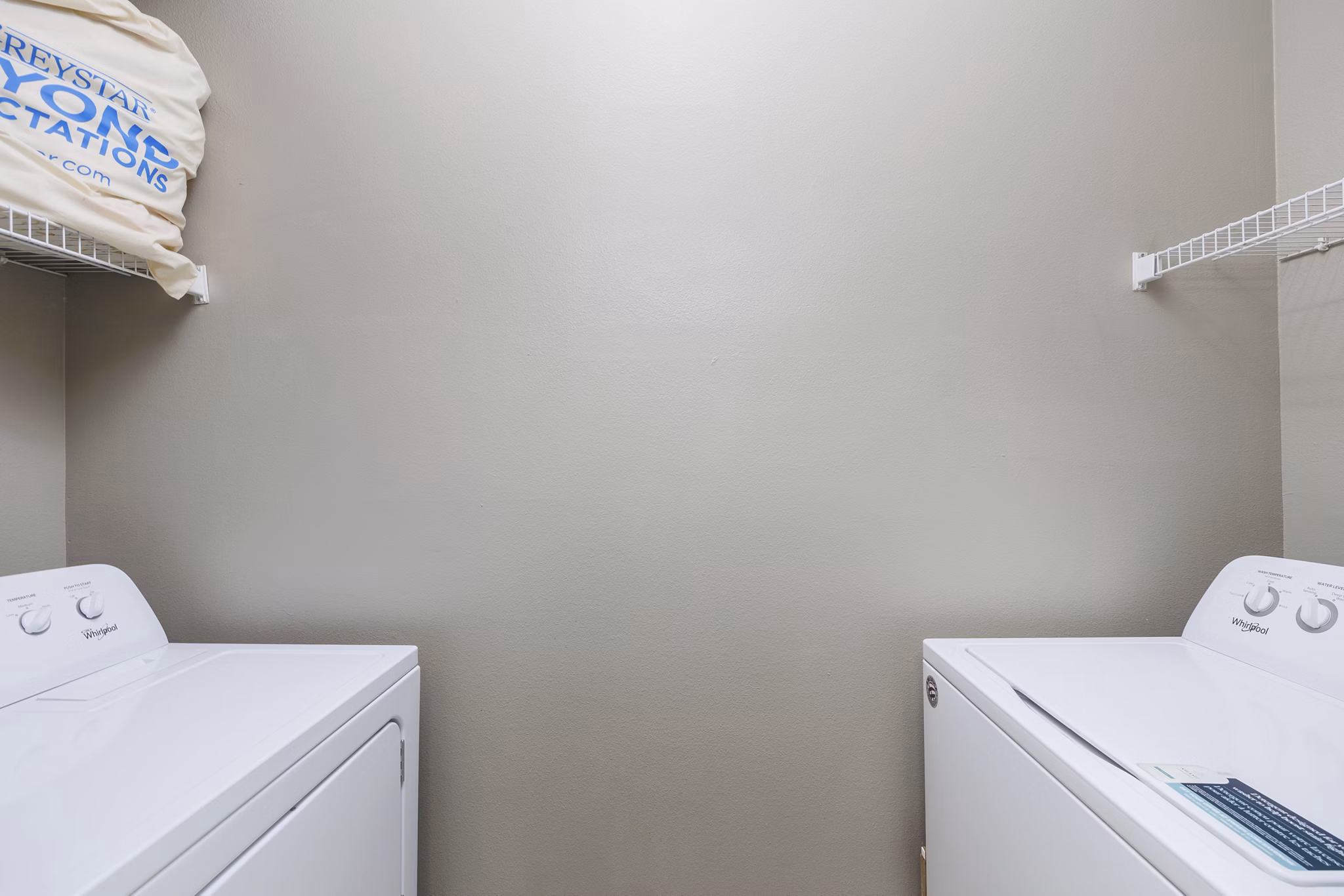 Laundry room featuring modern appliances in Clear Creek Meadows Apartments