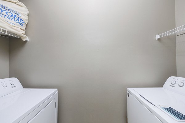 Laundry room featuring modern appliances in Clear Creek Meadows Apartments
