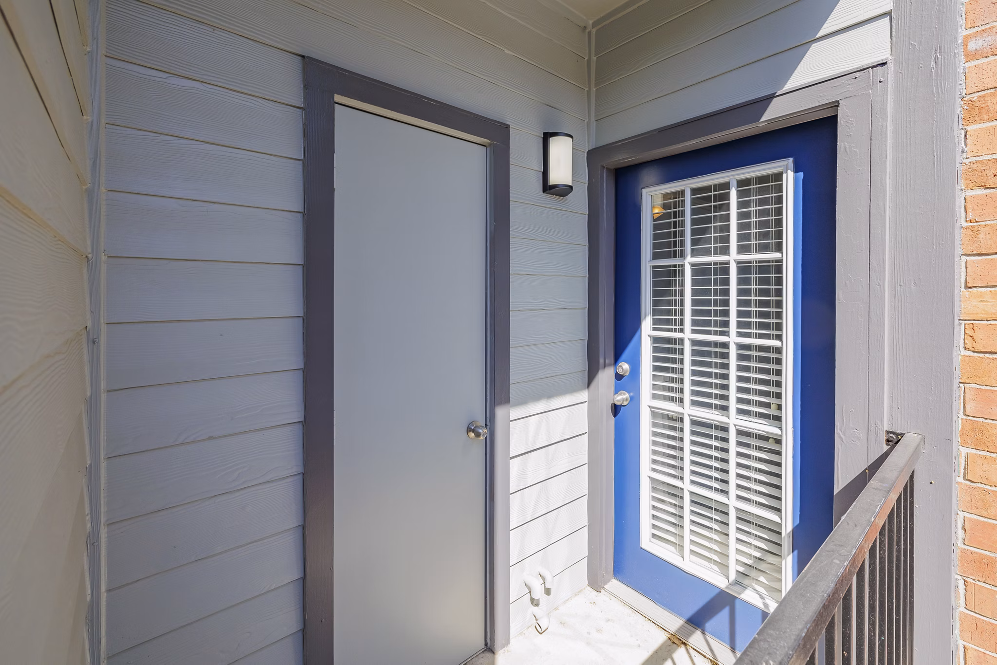 Cozy outdoor patio with seating and lush greenery at Clear Creek Meadows Apartments